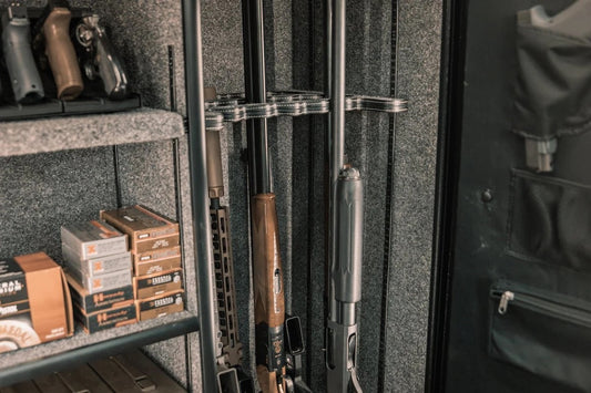 A gun safe with firearms and ammunition stored inside.
