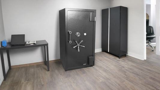 A large black safe in a minimalistic office space.