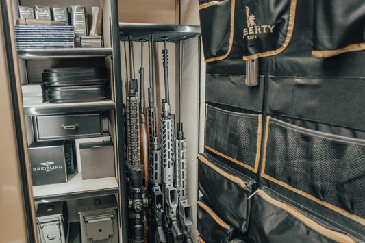 Interior of a gun safe with firearms and storage compartments.